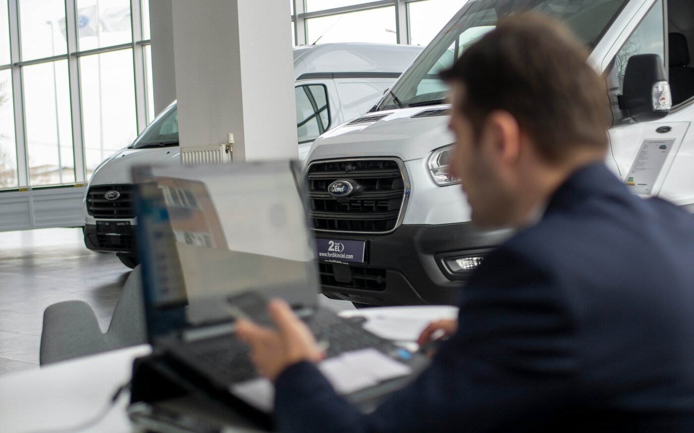 Small business owner managing rentals with car rental software on a laptop
